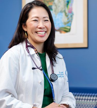 An MSK clinician smiles while speaking with a patient. 