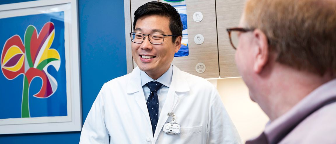 An MSK physician and a patient in a treatment room.