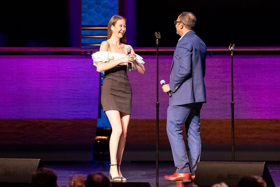 CvC24_IA teenage girl surprising Neerav Shukla, MD, onstage at Comedy vs Cancer 2024  mageCaro_Impact-Scarlett.jpg 